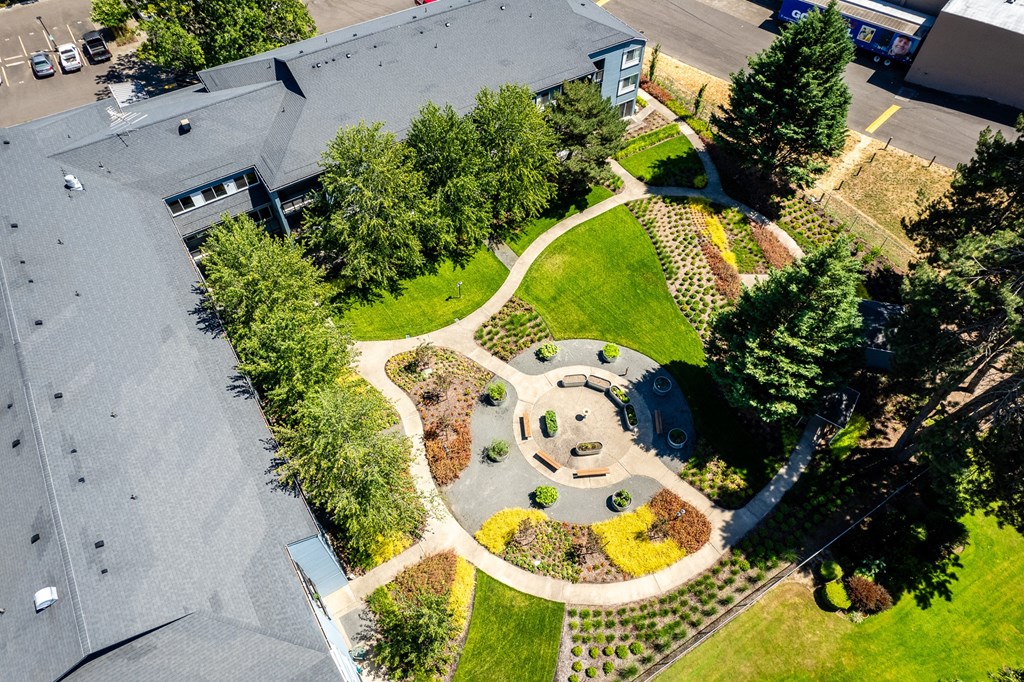 an aerial view of a park with trees and a building