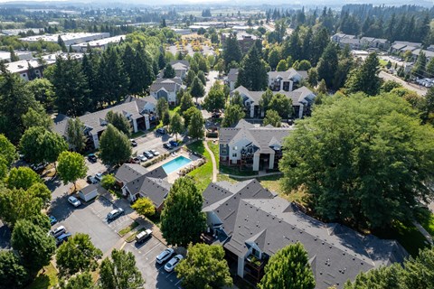 A bird's eye view of a residential area with houses and cars.