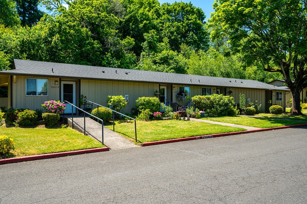 A building with a red trimmed walkway in front.