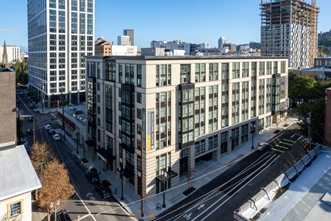 an aerial view of a large white building in the city