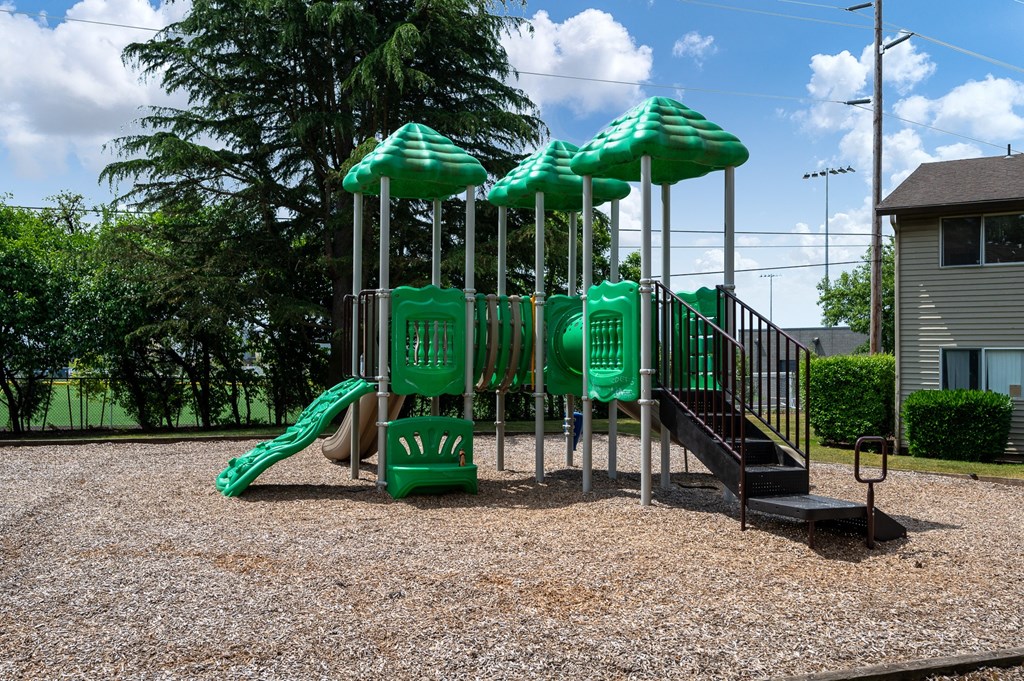 a playground with a slide and monkey bars