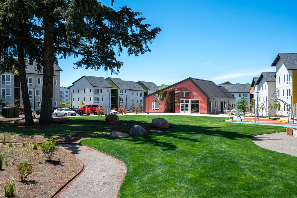 a view of a park with houses in the background