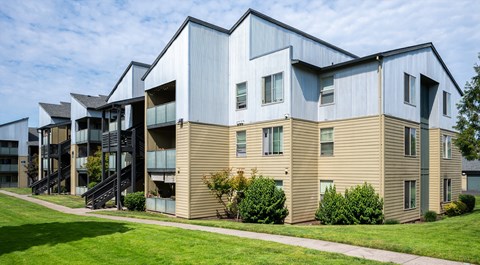 A modern building with a combination of beige and blue exterior.