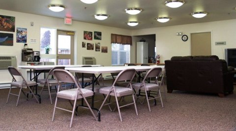 A conference room with a long table and chairs.