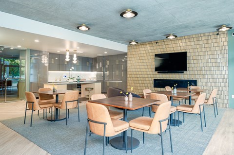 A modern dining room with a fireplace and a television.