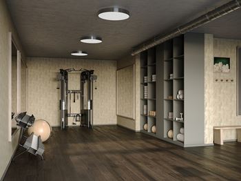 A gym with a weightlifting area and a bench.