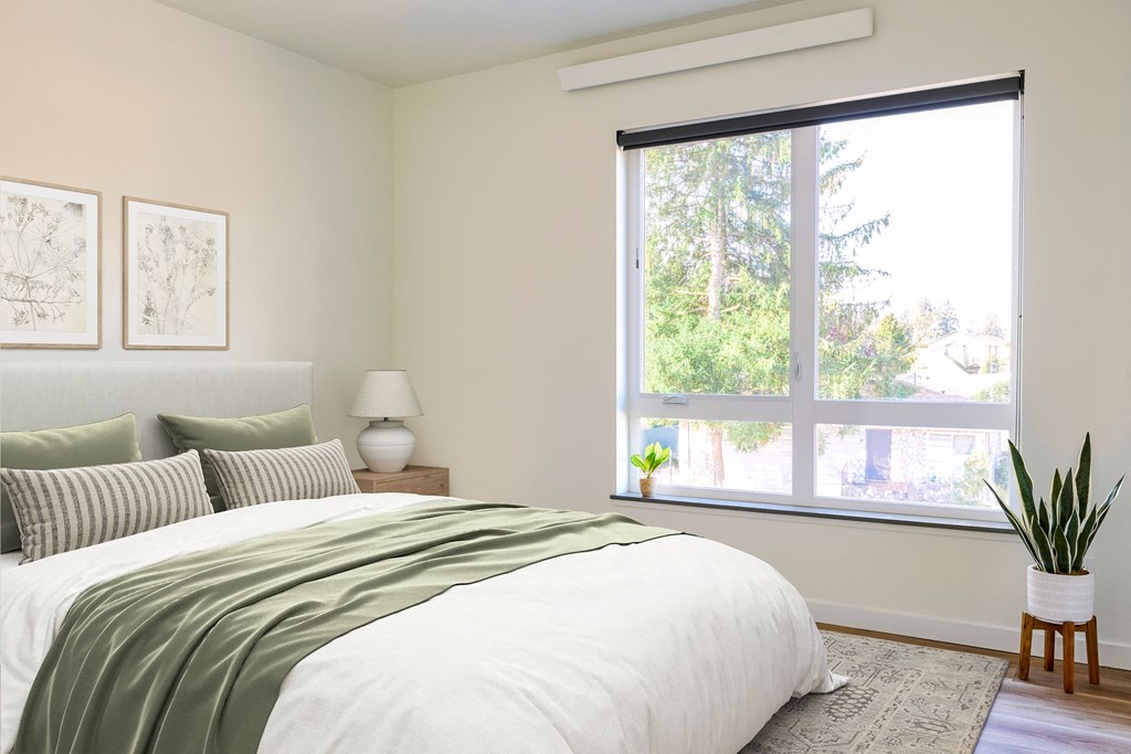 a bedroom with a bed and a large window