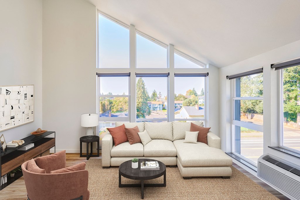 a living room with a couch and large windows