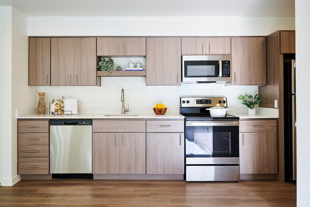a kitchen with wooden cabinets and stainless steel appliances