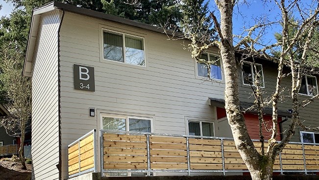 a house with a wooden fence in front of it