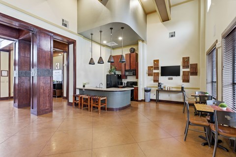 A kitchen with a dining table and chairs.