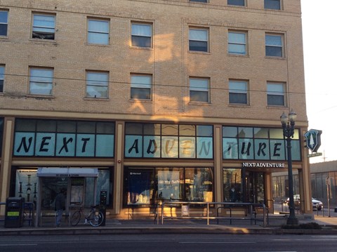 A building with the words "Next Adventure" on the front.