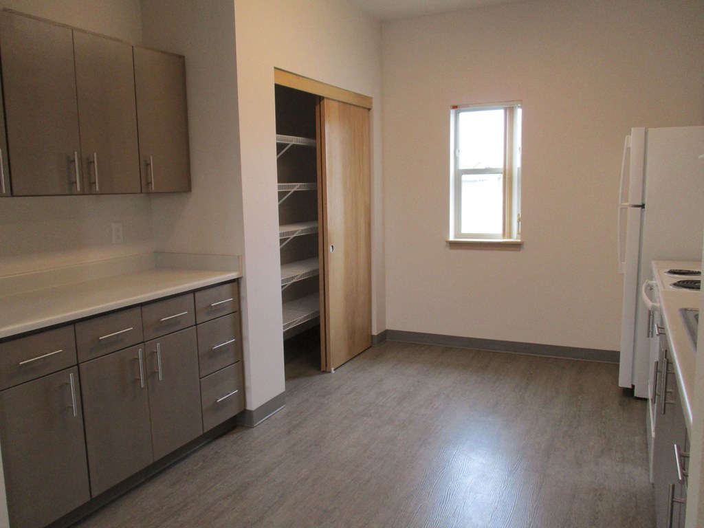 a kitchen with stainless steel cabinets and a window
