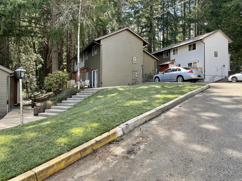 a house on the side of a street with a lawn