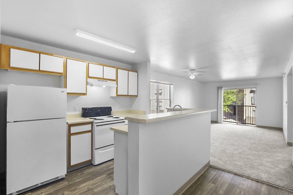 A kitchen with white appliances and cabinets.