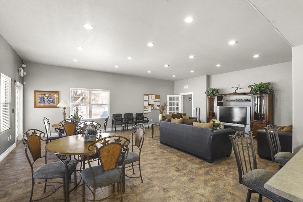A spacious living room with a dining table and chairs.