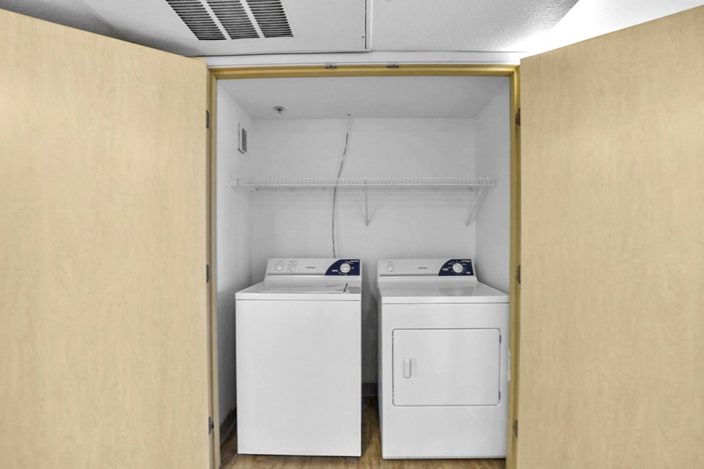 A small laundry room with a washer and dryer.