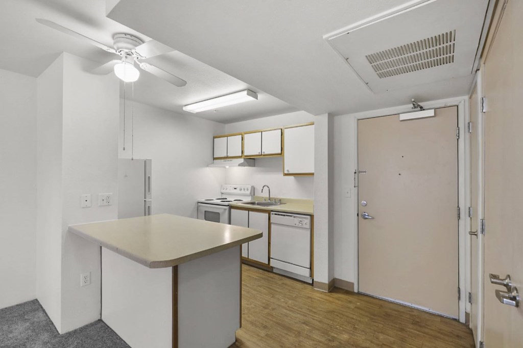 A kitchen with white cabinets and a table.