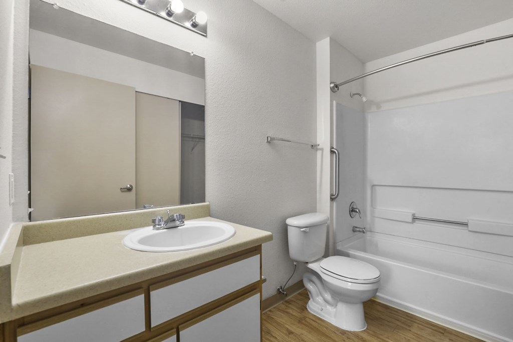 A white bathroom with a sink, toilet, and bathtub.
