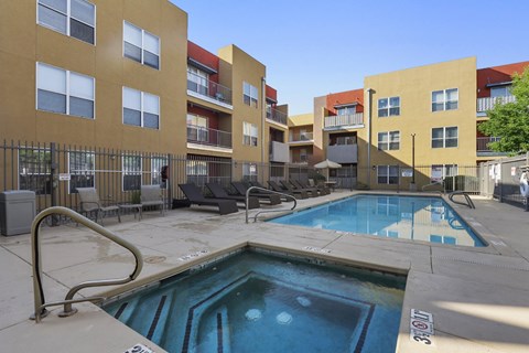 A swimming pool in front of apartment buildings.