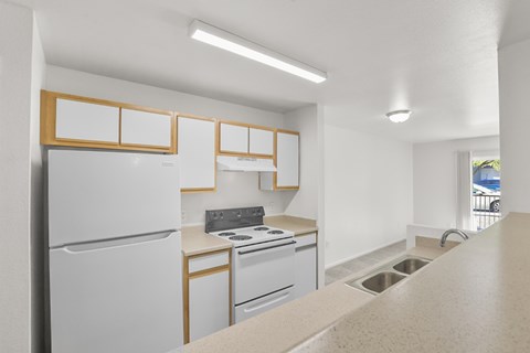 A kitchen with white appliances and wooden accents.