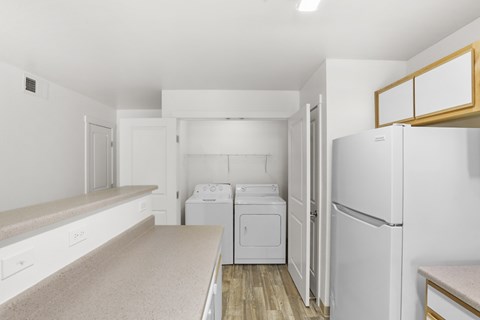 A white laundry room with a washer and dryer.
