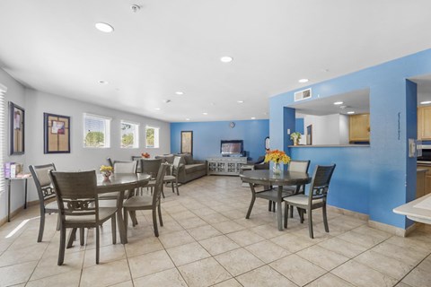 A dining room with a table set for six.