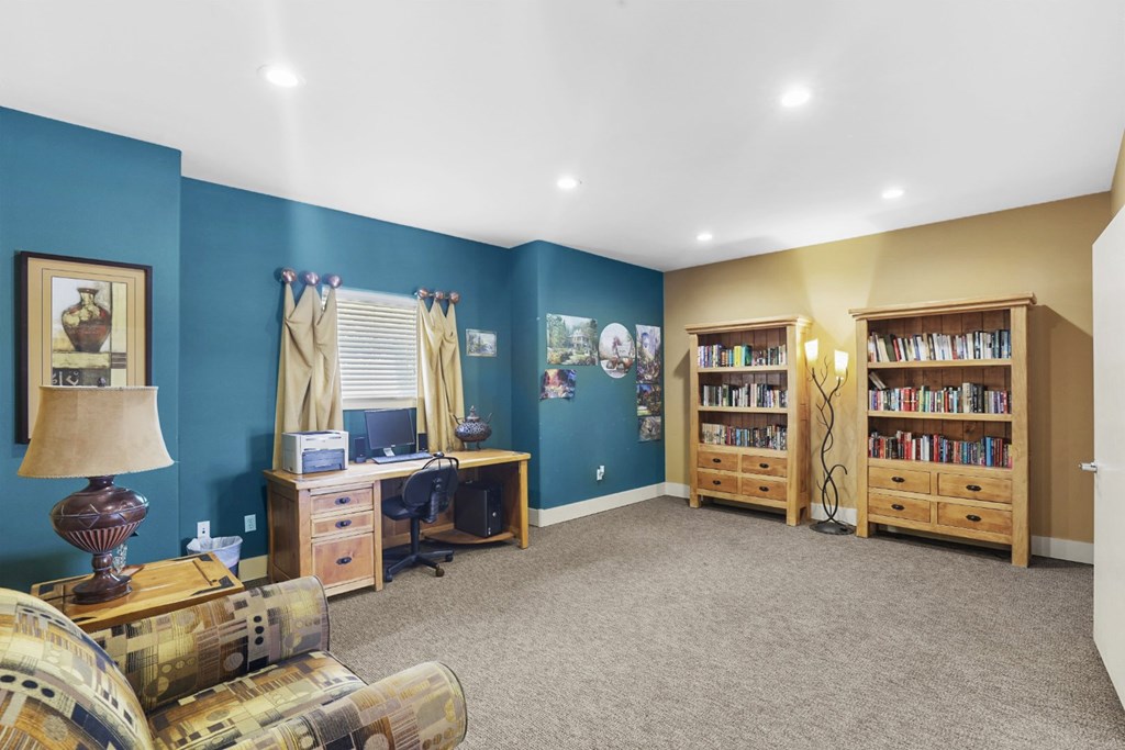 A room with a blue wall and a bookshelf.