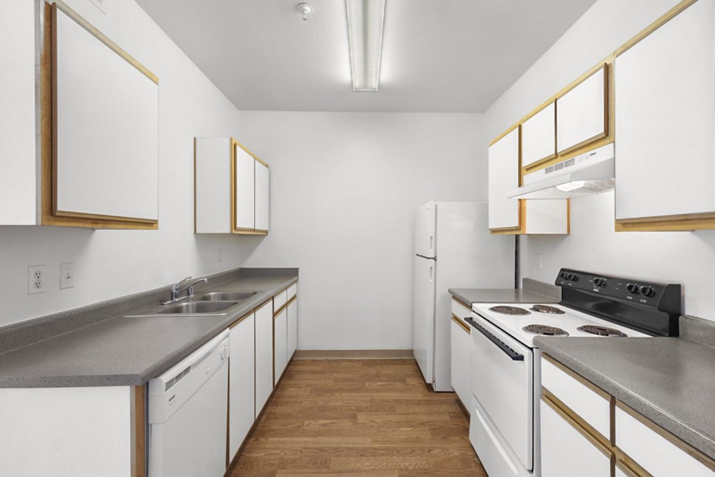 A kitchen with white cabinets and a black stove top oven.