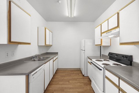 A kitchen with white cabinets and a black stove top oven.