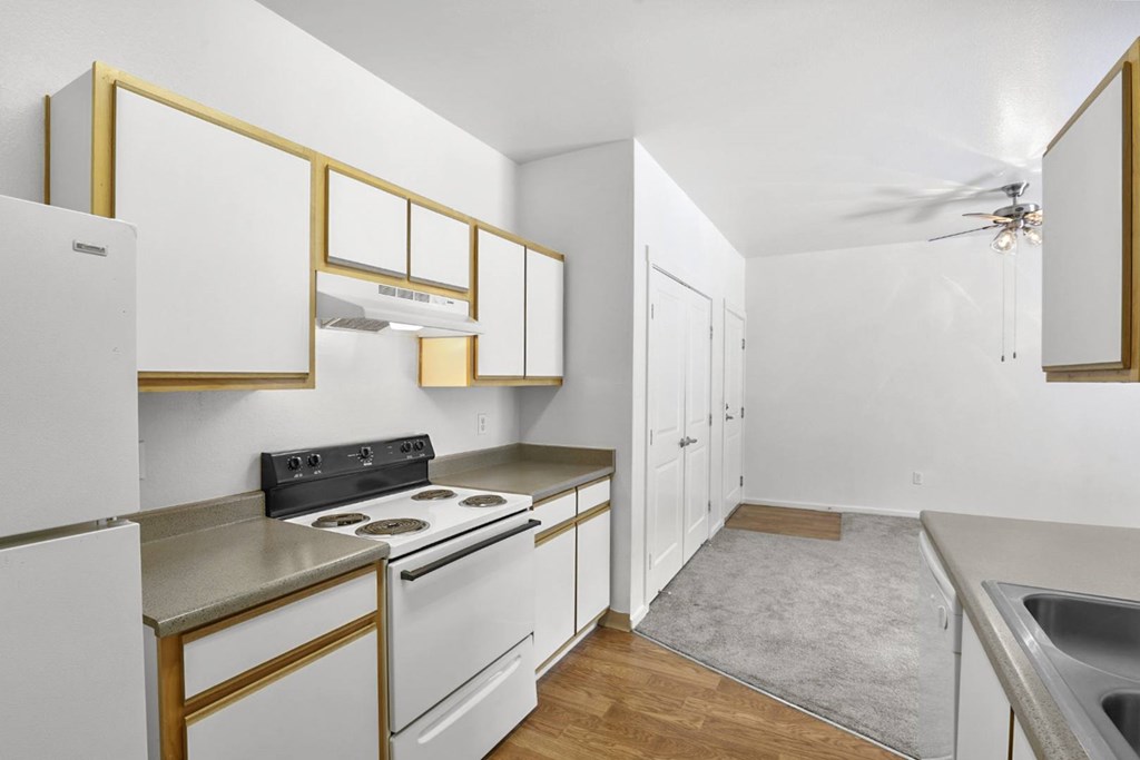 A kitchen with white cabinets and a black stove top.