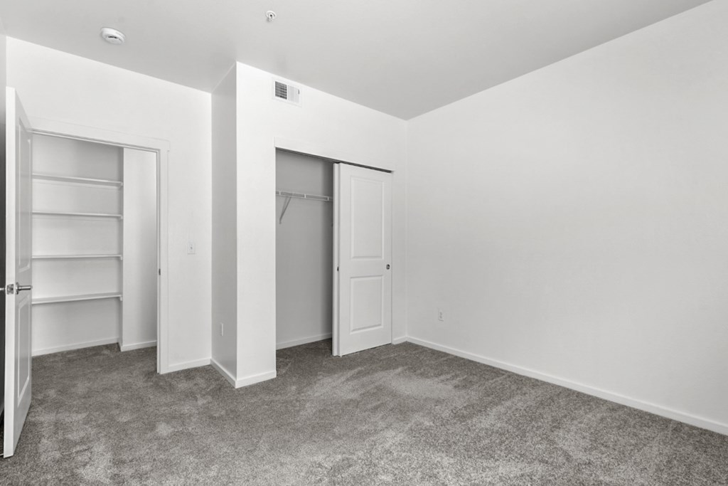A room with a carpeted floor and white walls.