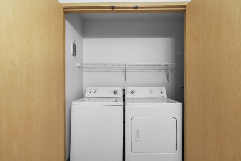 A small laundry room with a washer and dryer.