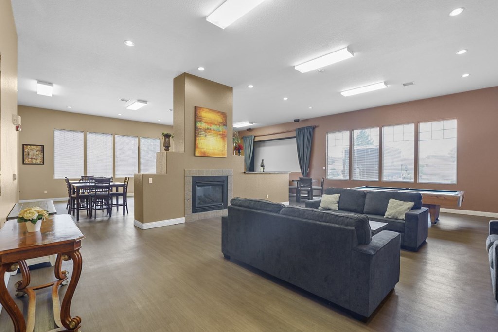 A living room with a grey couch and a wooden table.