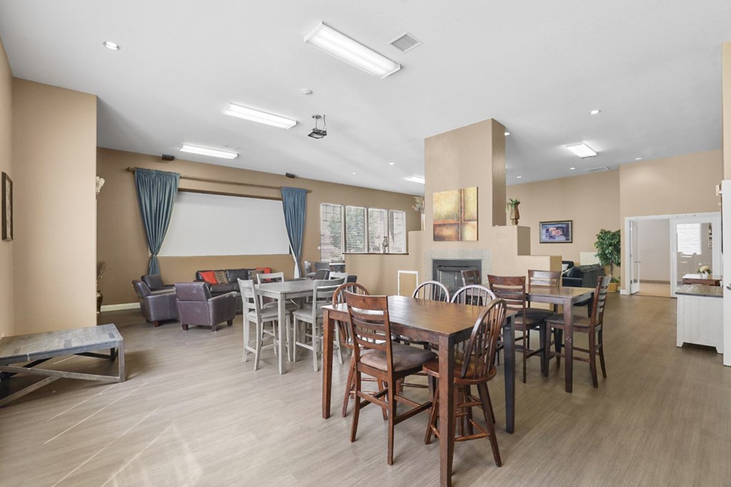 A dining room with a table set for six people.