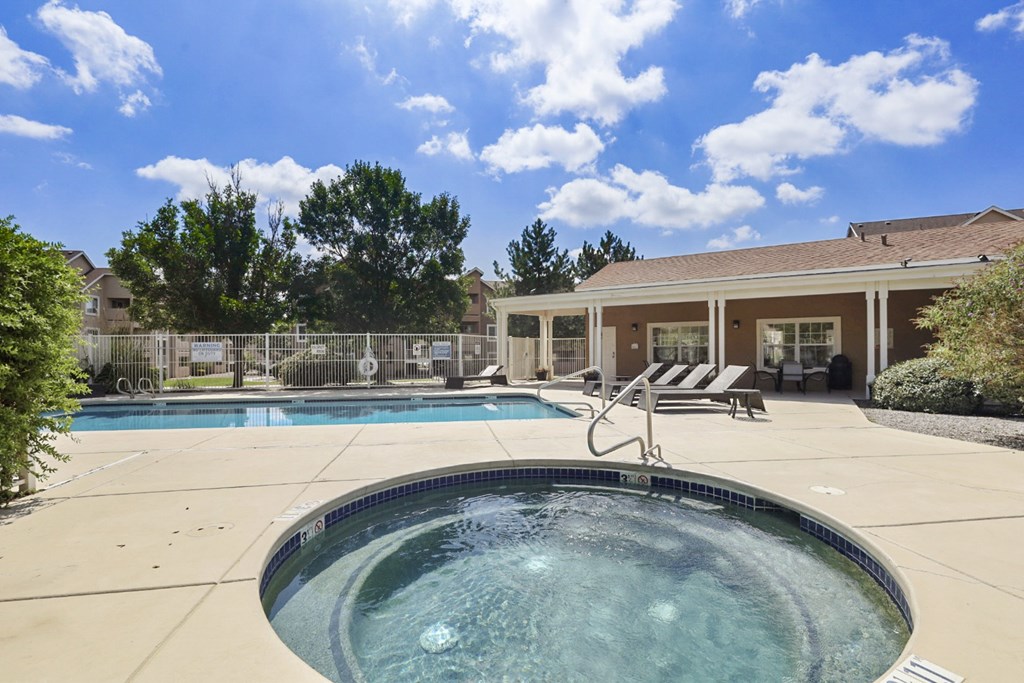 A hot tub sits in the middle of a patio.