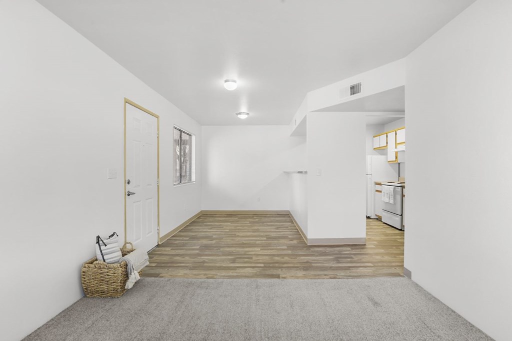 A room with white walls and a wooden floor.