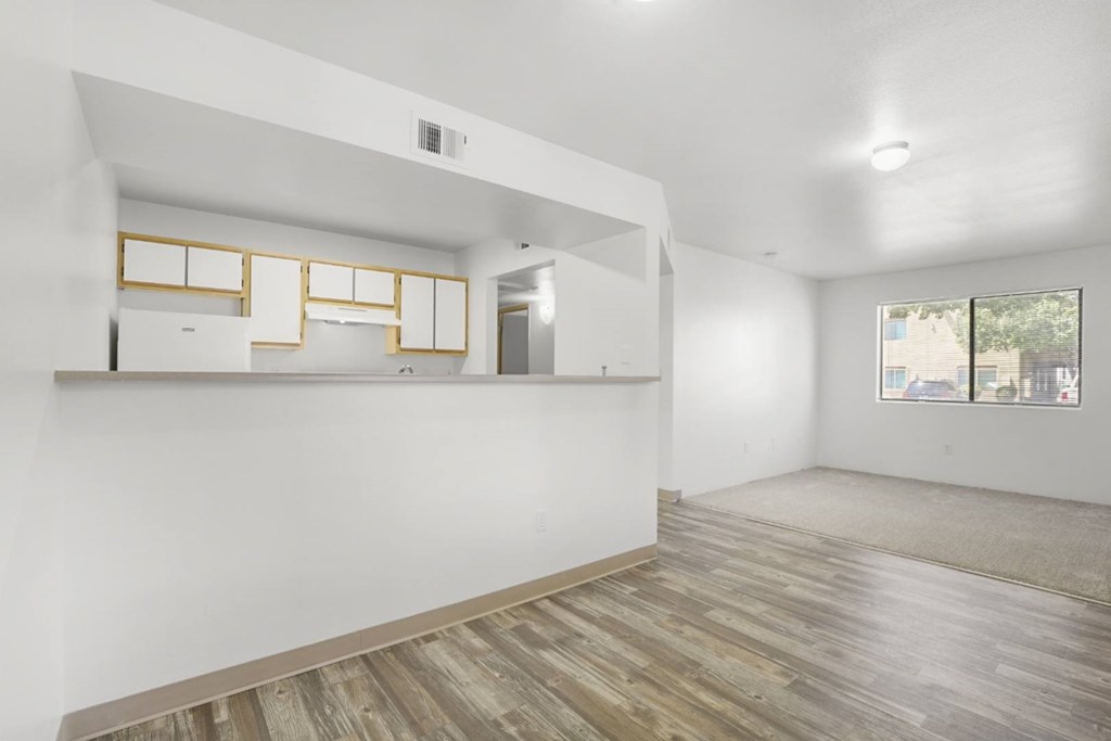 A room with wooden floors and white walls.