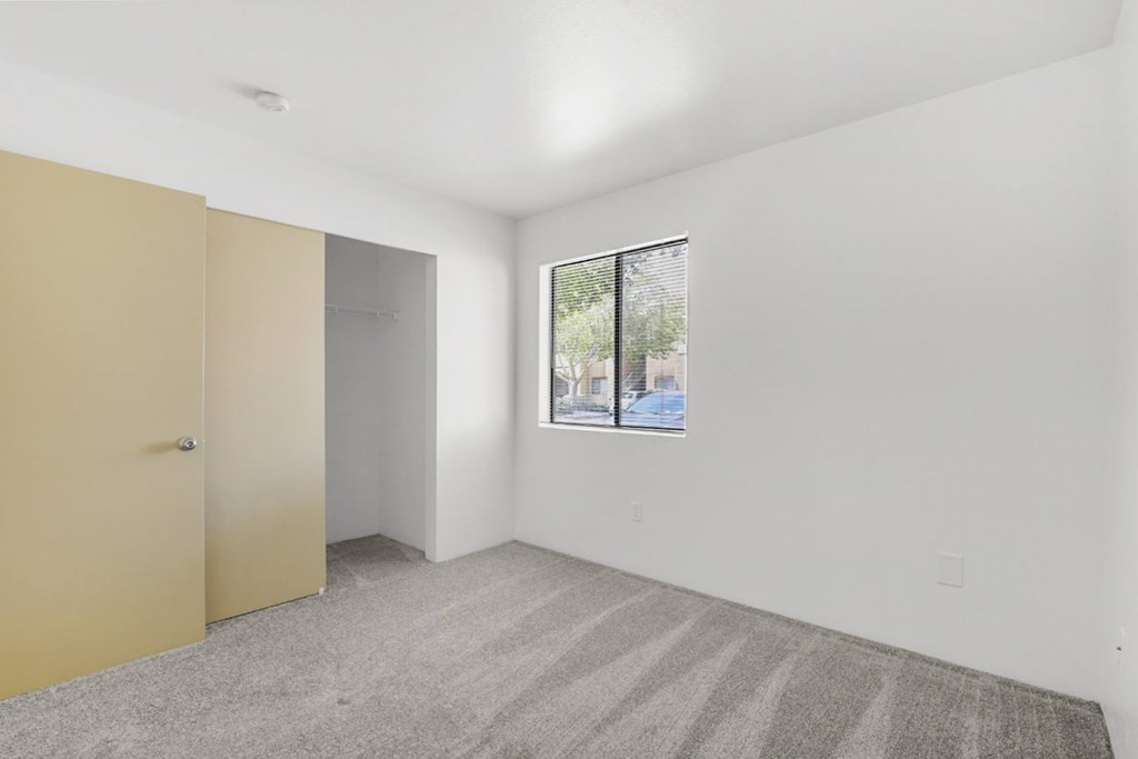 A room with a tan door and a striped carpet.