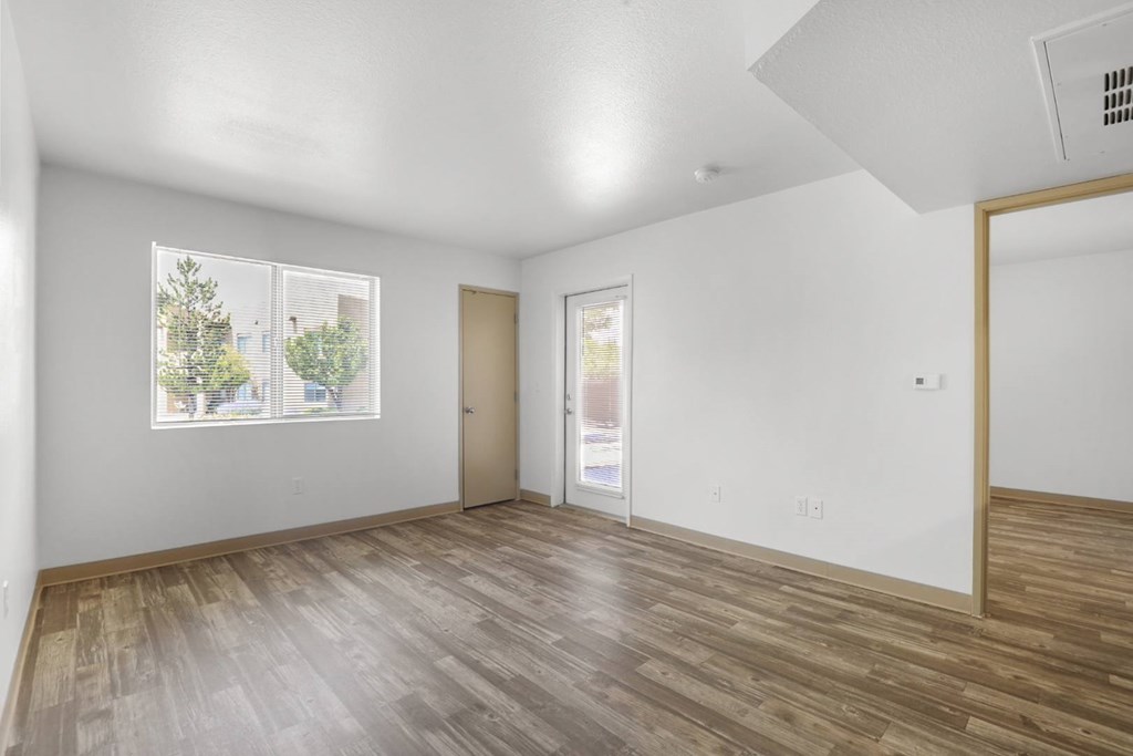 A room with wooden floors and white walls.