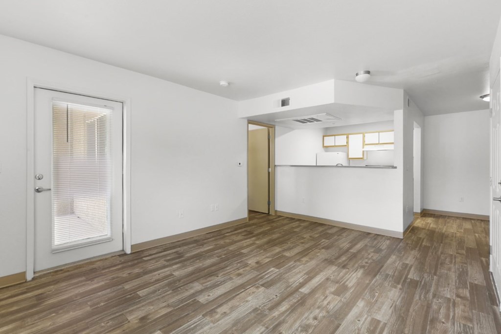 A room with a wooden floor and white walls.