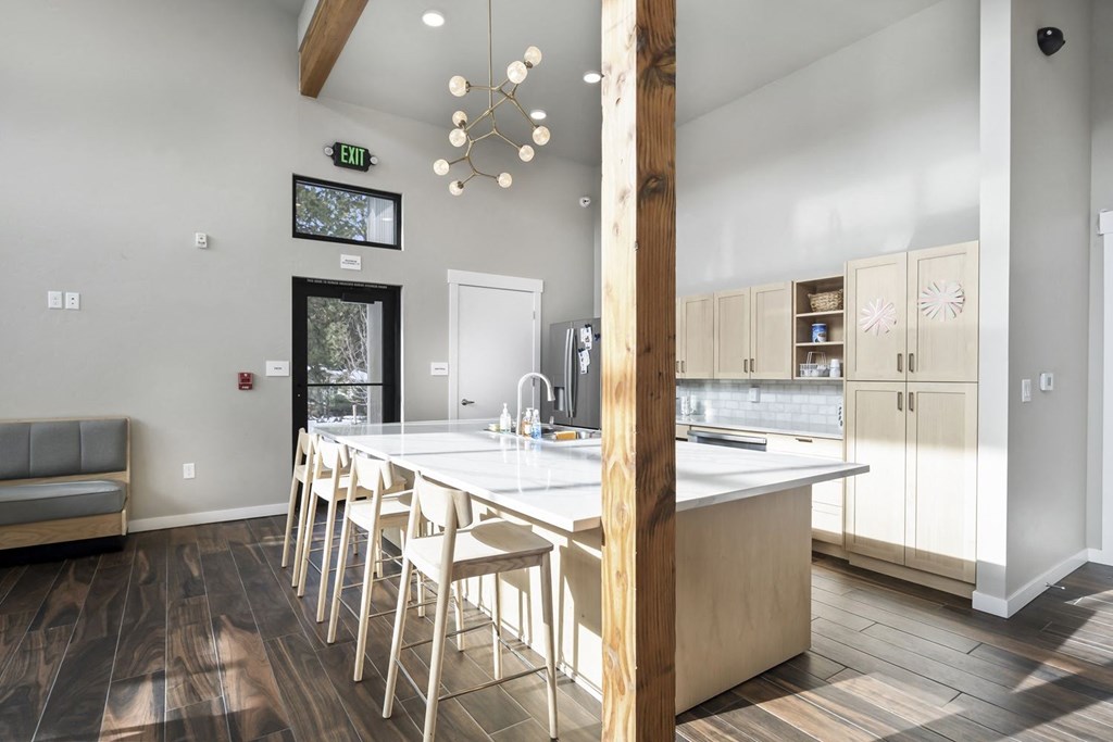 a view of a kitchen with a bar and stools