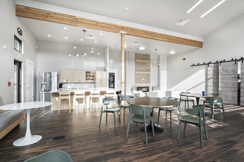 a dining room and kitchen with a table and chairs