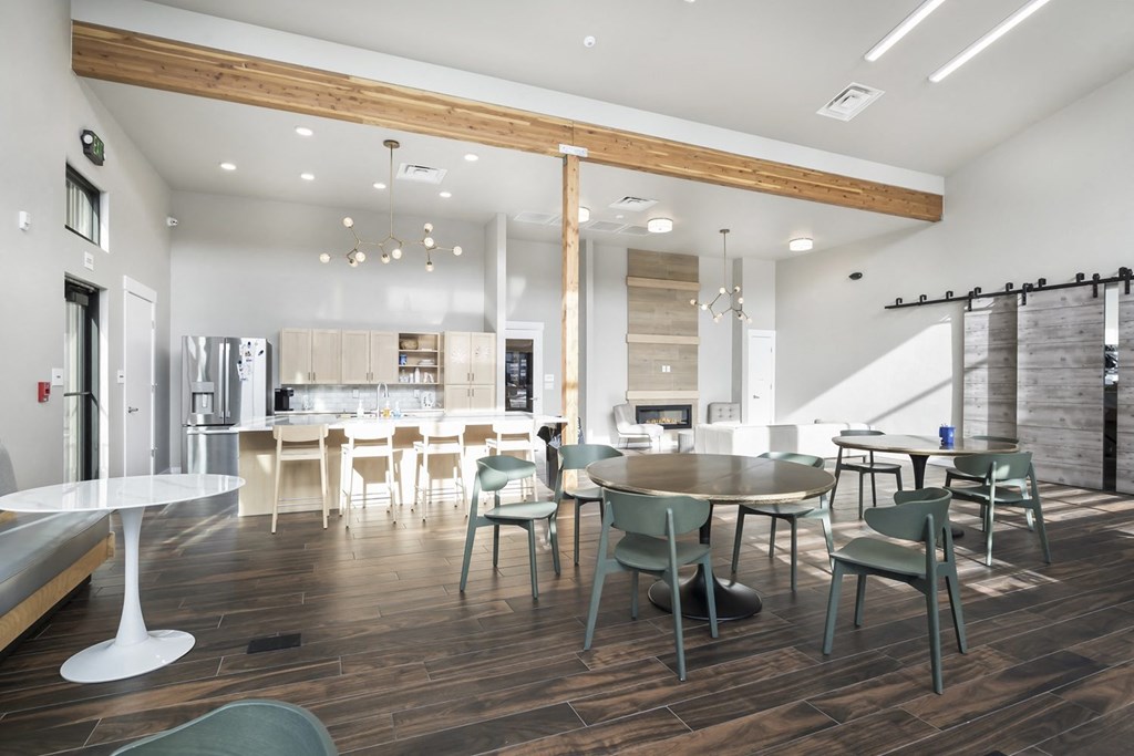 a dining room and kitchen with a table and chairs
