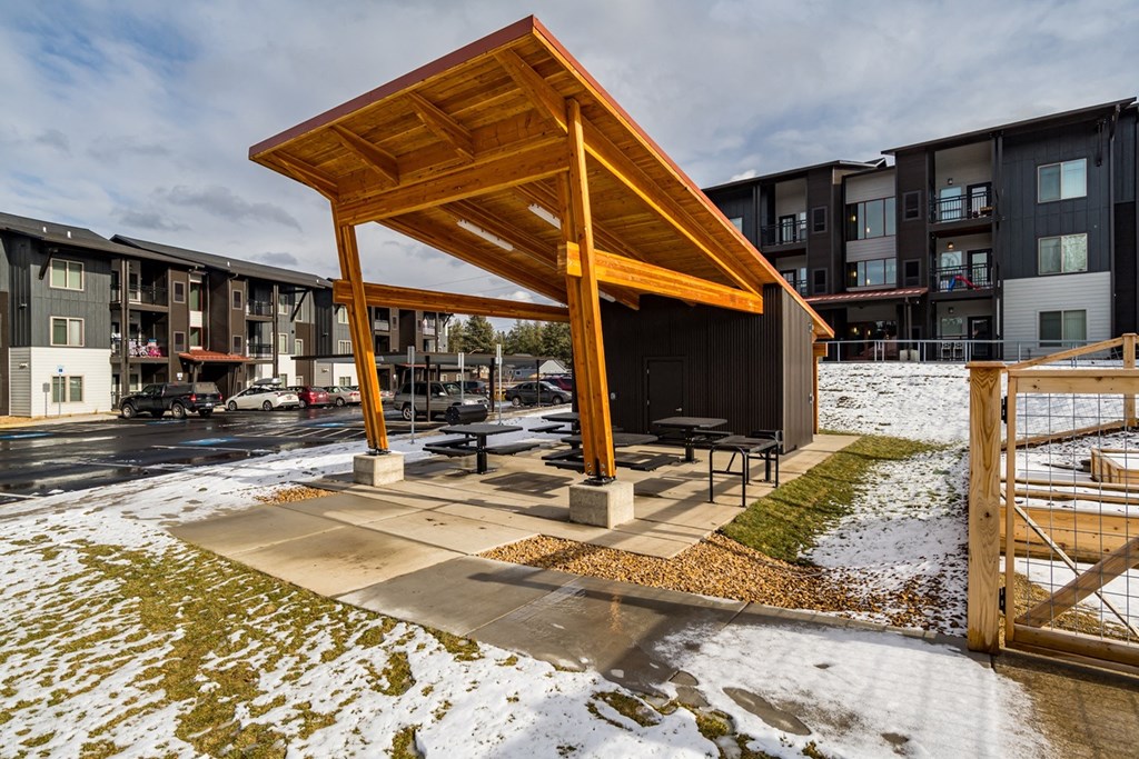 a pavilion with picnic tables in the snow