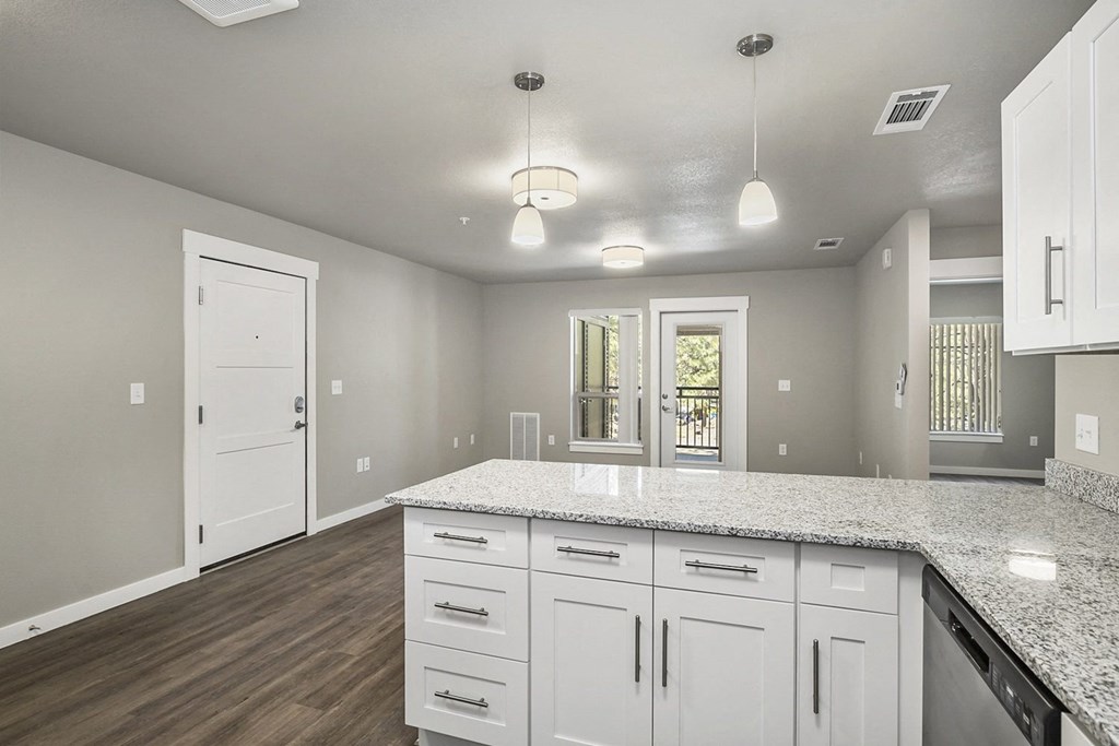 a large kitchen with white cabinets and stainless steel appliances