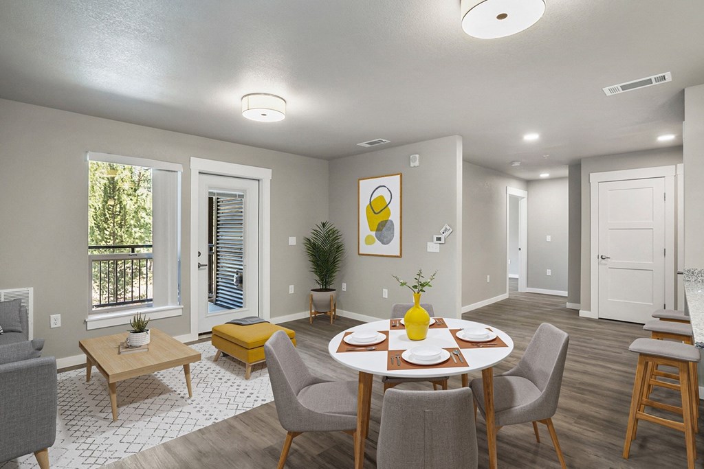 an open living room and dining room with a table and chairs