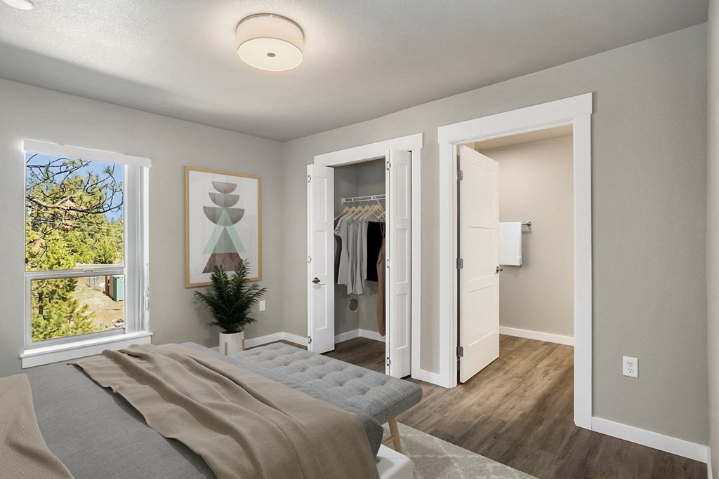 the master bedroom of a new home with a closet and a bed