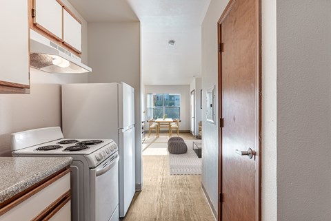 A small kitchen with a stove top oven and a refrigerator.