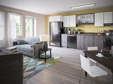 A modern kitchen with a grey fridge and white cabinets.